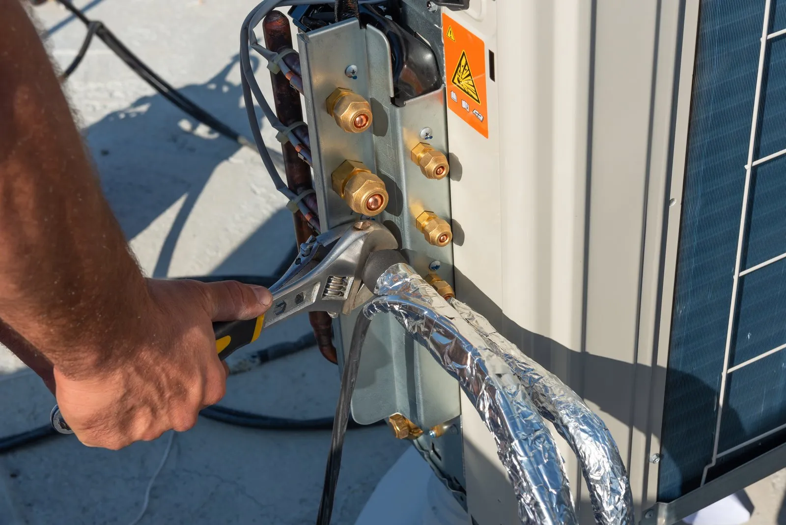 Illustrative stock photo — an HVAC technician working on an outdoor AC installation; not an actual Lake Havasu AC Guide job site.